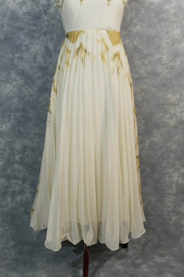 Golden Feather Chiffon Top Set — Cream chiffon with golden feather prints, pearl & stone embellishments on the neckline, flowing pleated skirt. Elegant & festive for special occasions.