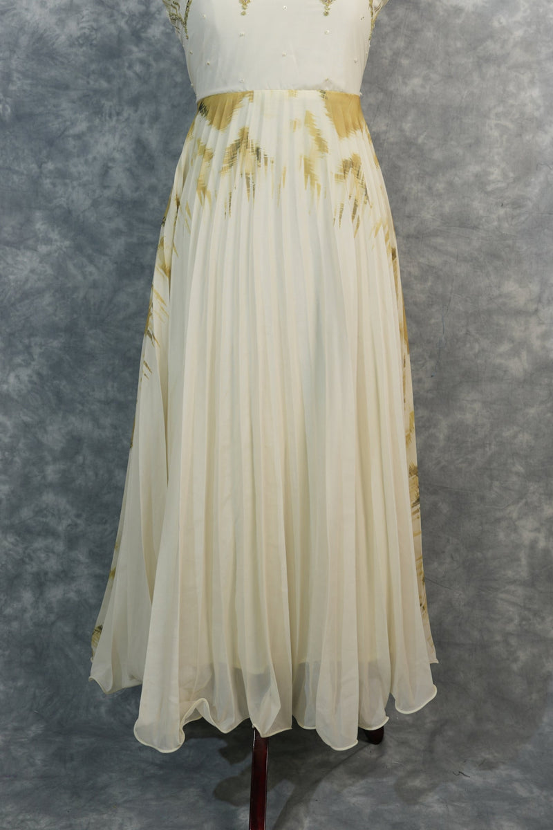 Golden Feather Chiffon Top Set — Cream chiffon with golden feather prints, pearl & stone embellishments on the neckline, flowing pleated skirt. Elegant & festive for special occasions.
