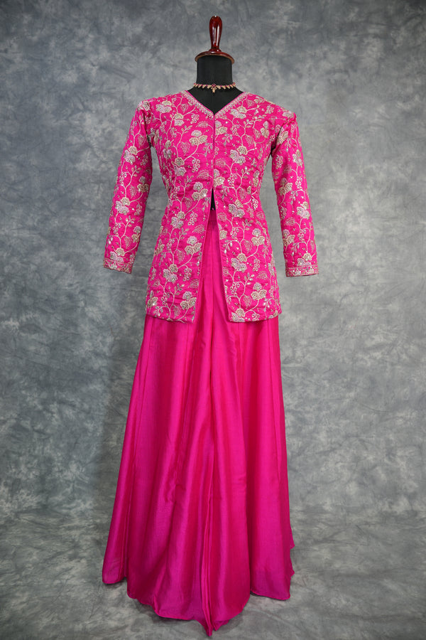 Pink traditional outfit with floral patterns on a gray background