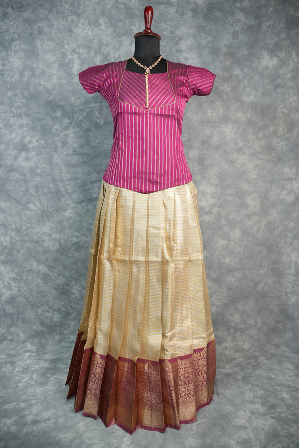 Pink and gold saree on a mannequin against a gray background