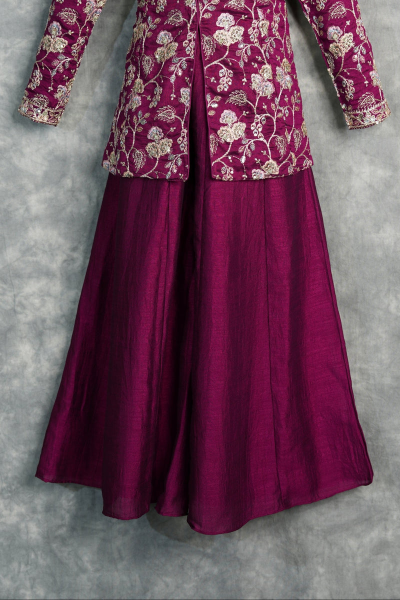 Traditional outfit with floral patterned top and solid bottom on a gray background