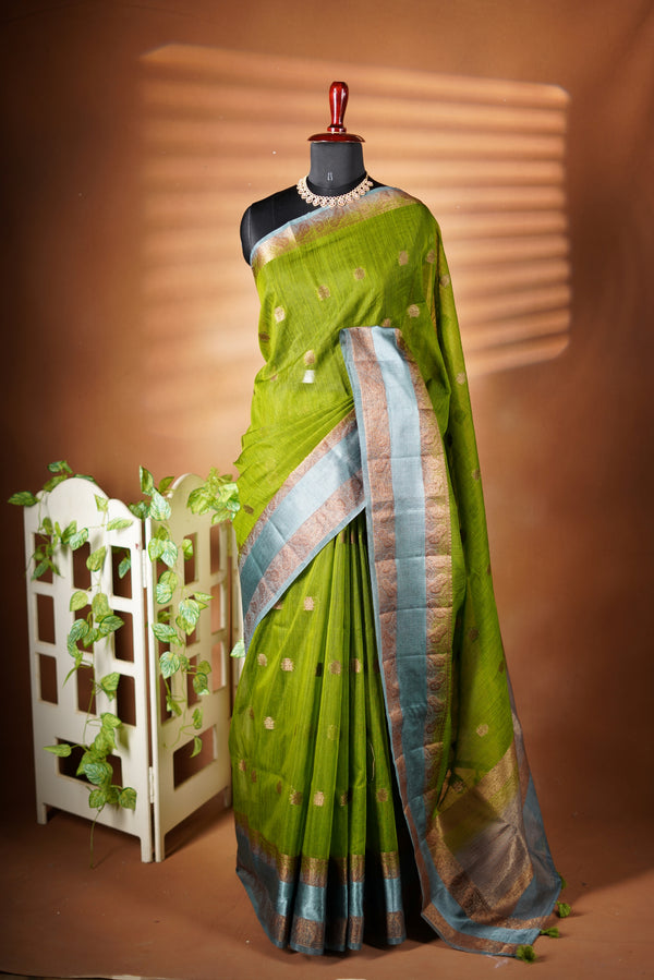 Green Kora cotton saree - Styled in a natural green colour, this Kora Cotton saree creates a comfort and rich look with copper contrast border, paired with a matching blouse