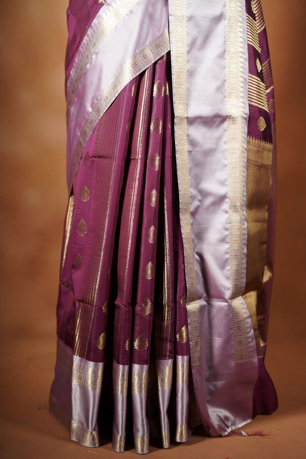 Kancheepuram Silk Saree - Maroon bodice with golden lurex line through the saree designed with rich border pattern work with zari buttas add on matching silk blouse piece.