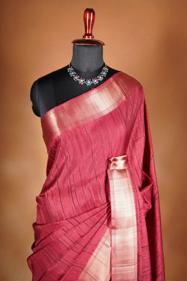 Crimson Red Semi Tussar Saree | Gold Zari Border Plain Body | Traditional Festive WearCrimson red Semi Tussar Saree - The rich hue is elevated with a smooth texture and a shimmering zari border and attached blouse that enhances its festive appeal