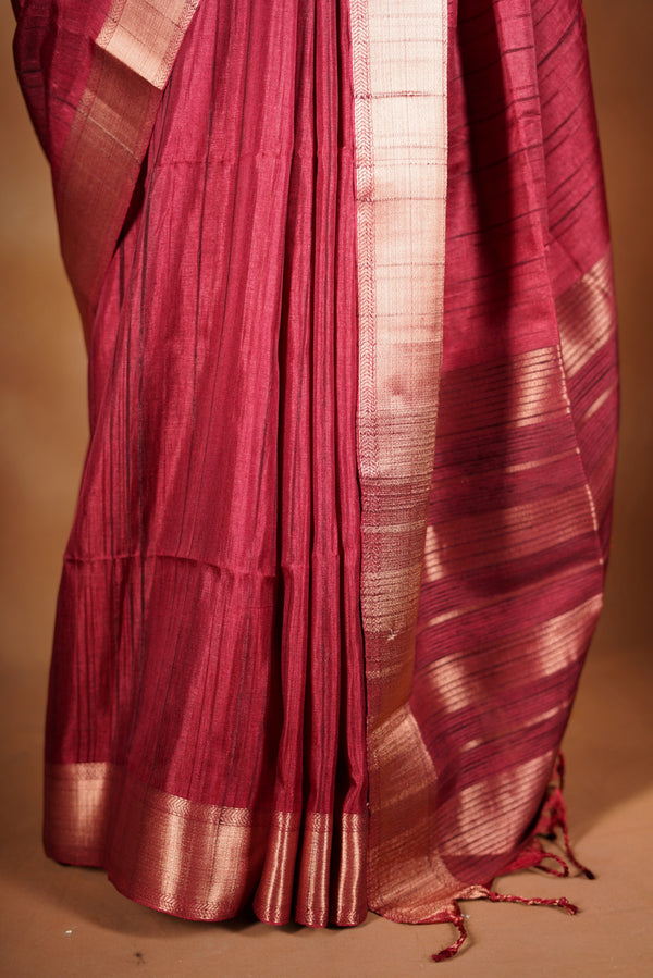 Crimson Red Semi Tussar Saree | Gold Zari Border Plain Body | Traditional Festive WearCrimson red Semi Tussar Saree - The rich hue is elevated with a smooth texture and a shimmering zari border and attached blouse that enhances its festive appeal