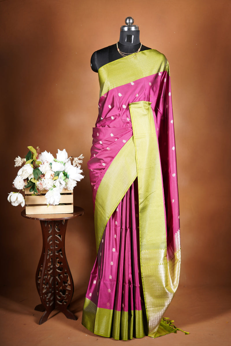 Soft Silk Saree –  rasberry pink bodice with contrast border Elegant shimmer drape featuring lurex check pattern shiny metallic threads woven in a grid design with stylish green border. Comes with attached blouse. Lightweight, blending modern sparkle.