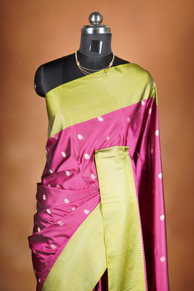 Soft Silk Saree –  rasberry pink bodice with contrast border Elegant shimmer drape featuring lurex check pattern shiny metallic threads woven in a grid design with stylish green border. Comes with attached blouse. Lightweight, blending modern sparkle.