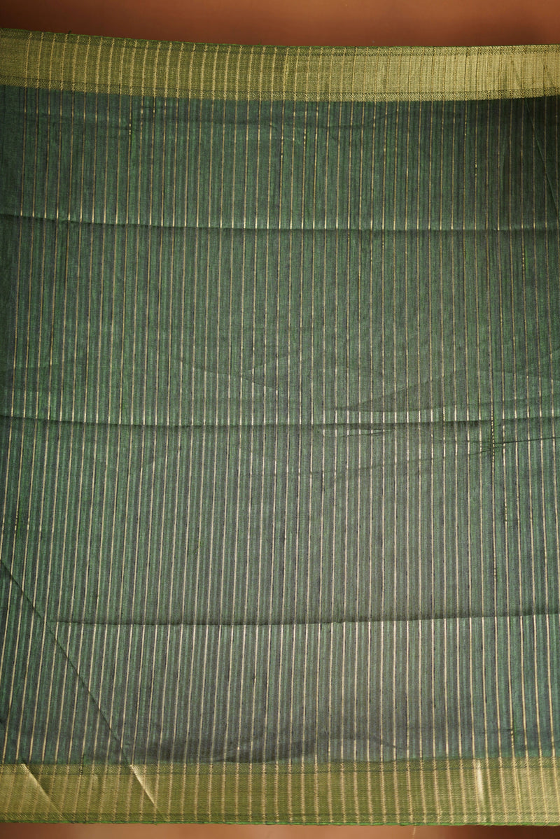 Antique Gree Semi Tussar Saree - Deep, rich Green with a luminous golden finish.Premium Features a wide, lustrous golden zari border and a grand pallu adorned with classic horizontal stripes and delicate tassel accents
