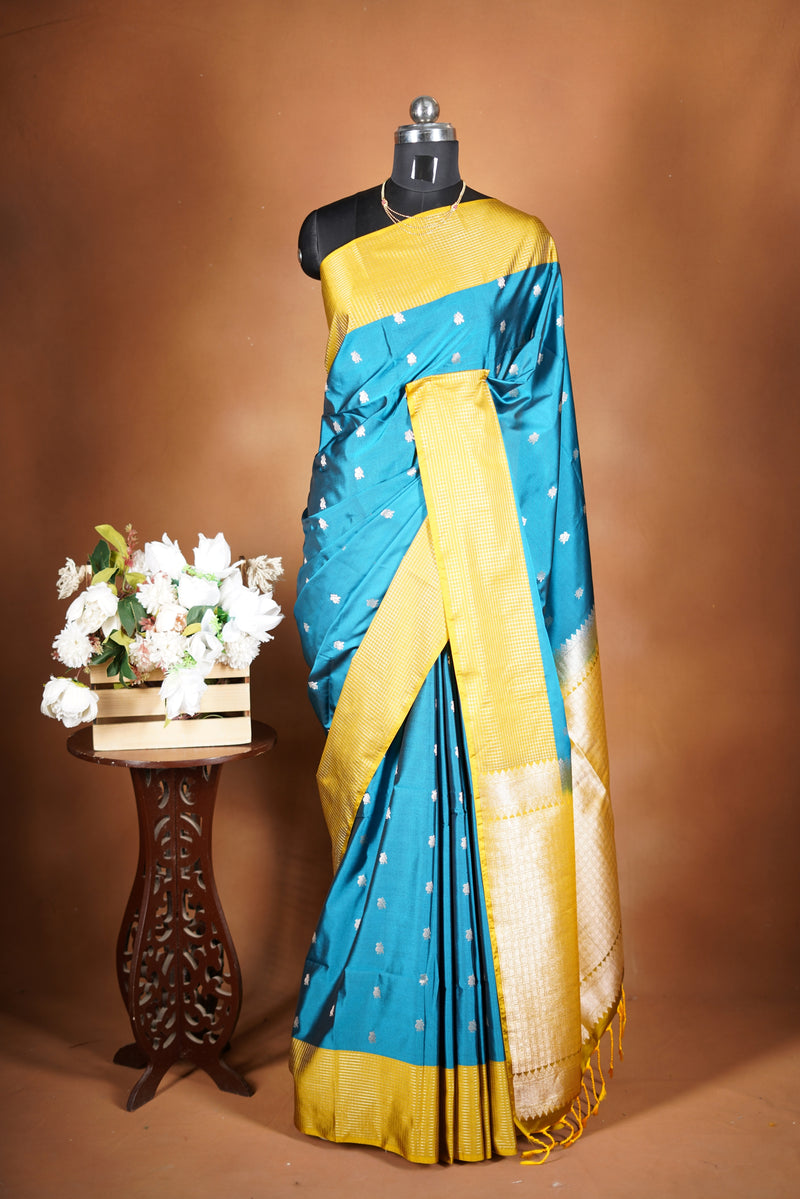 Soft Silk Saree–vibrant blue bodicve with contrast border Elegant shimmer drape featuring lurex check pattern shiny metallic threads woven in a grid design with stylish yellow  border. Comes with attached blouse. Lightweight, blending modern sparkle.