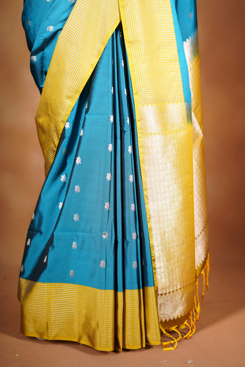 Soft Silk Saree–vibrant blue bodicve with contrast border Elegant shimmer drape featuring lurex check pattern shiny metallic threads woven in a grid design with stylish yellow  border. Comes with attached blouse. Lightweight, blending modern sparkle.