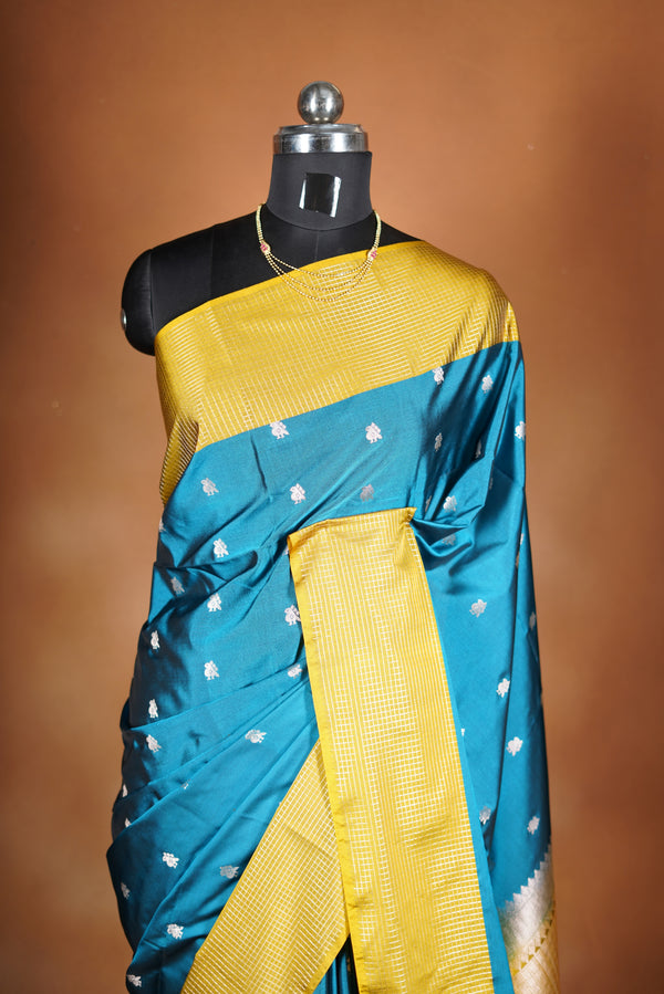 Soft Silk Saree–vibrant blue bodicve with contrast border Elegant shimmer drape featuring lurex check pattern shiny metallic threads woven in a grid design with stylish yellow  border. Comes with attached blouse. Lightweight, blending modern sparkle.