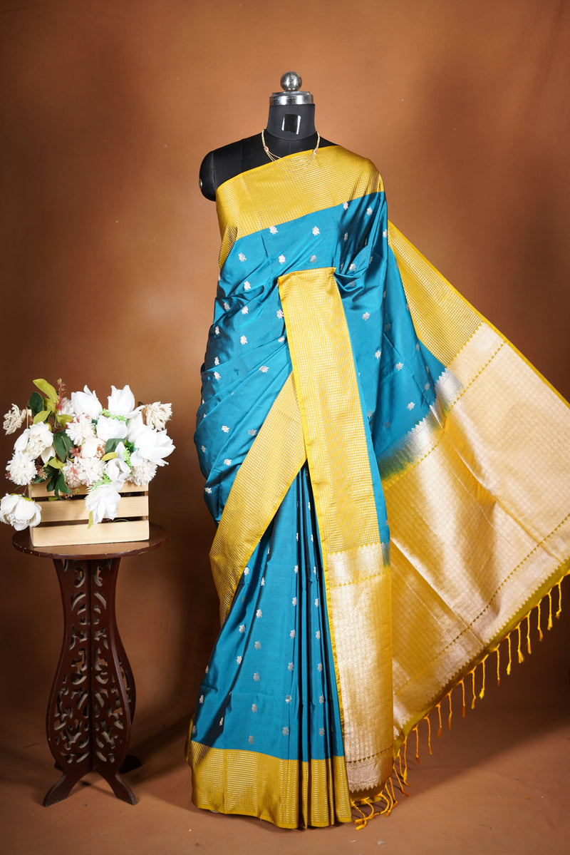 Soft Silk Saree–vibrant blue bodicve with contrast border Elegant shimmer drape featuring lurex check pattern shiny metallic threads woven in a grid design with stylish yellow  border. Comes with attached blouse. Lightweight, blending modern sparkle.
