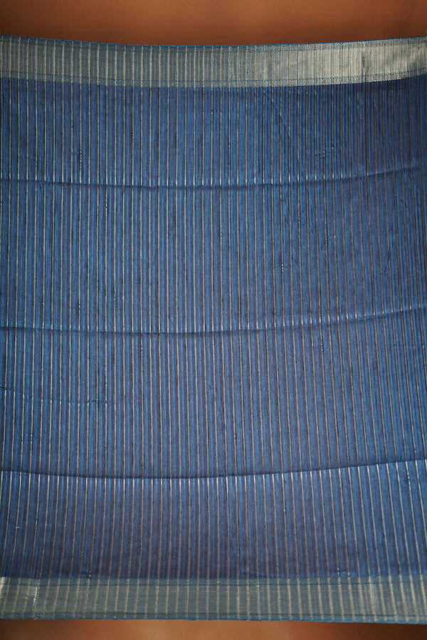 Dark slate blue Semi Tussar - Features a contrasting silver zari border and a grand pallu detailed with classic horizontal stripes and matching tassel fringe.