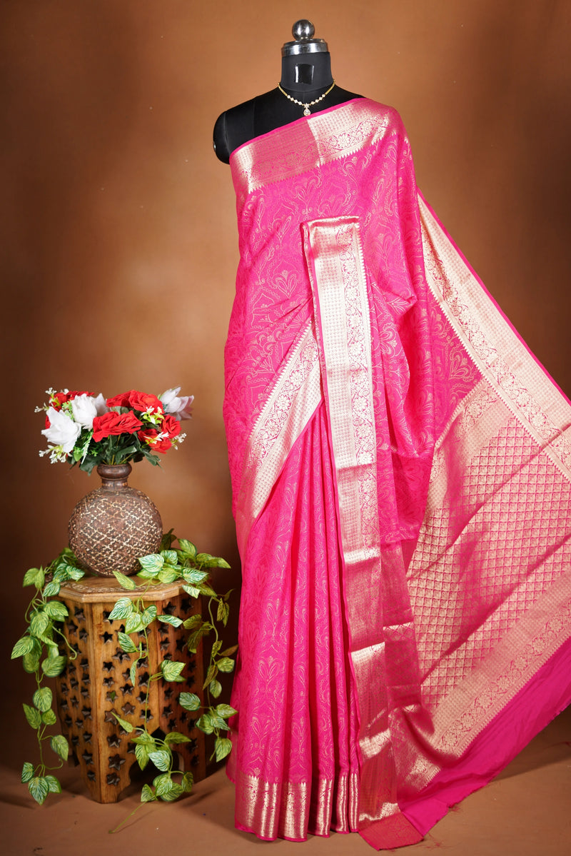 Bright Pink Geogrette Saree- Featuring all over gold floral zari weaving, rich textured patterns, and a broad gold zari border and pallu, giving a luxurious, elegant, and traditional festive look