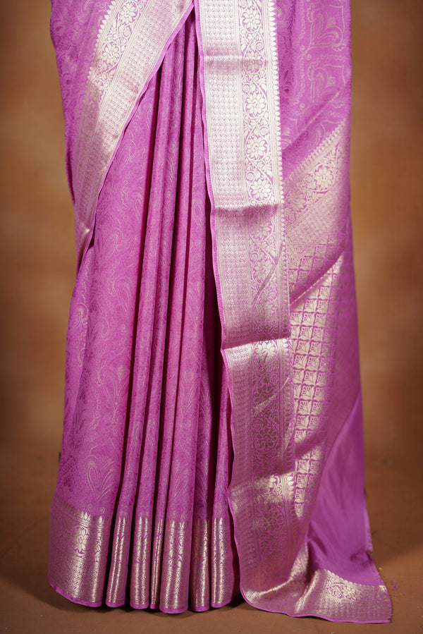 Pink Georgette Saree -  featuring a soft shimmer and intricate woven detailing the floral zari weave. The gentle pastel tone enhances its feminine charm, while the zari border adds a refined finish.