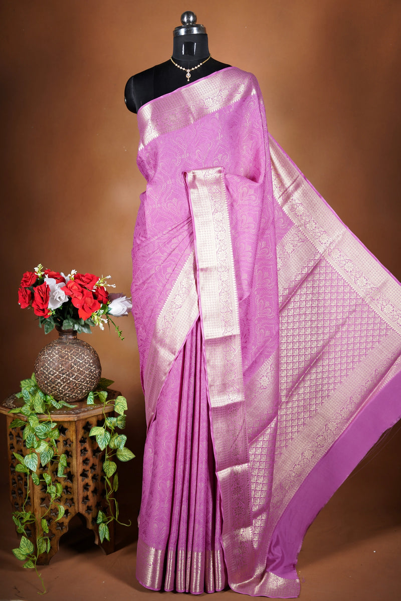 Pink Georgette Saree -  featuring a soft shimmer and intricate woven detailing the floral zari weave. The gentle pastel tone enhances its feminine charm, while the zari border adds a refined finish.