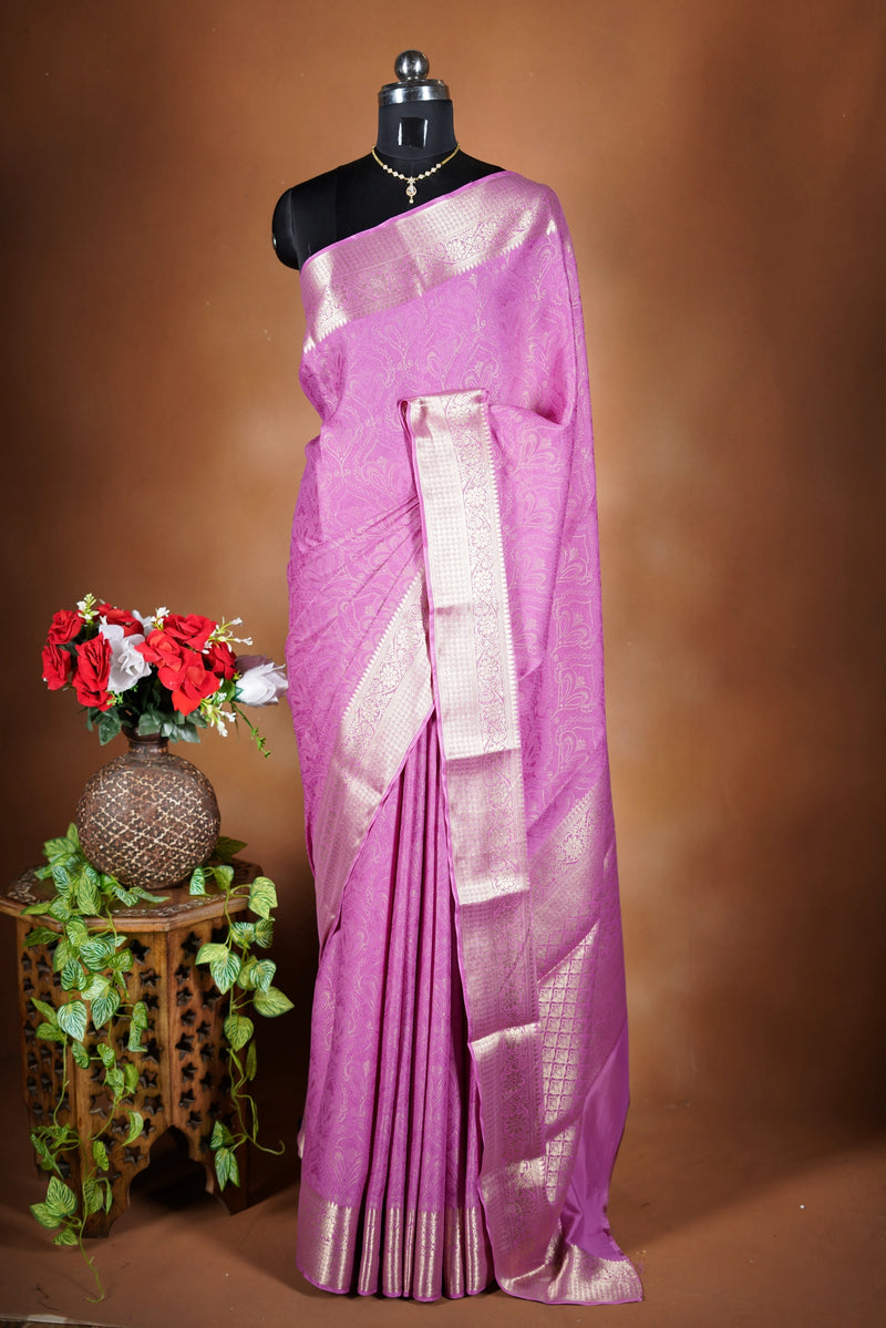 Pink Georgette Saree -  featuring a soft shimmer and intricate woven detailing the floral zari weave. The gentle pastel tone enhances its feminine charm, while the zari border adds a refined finish.