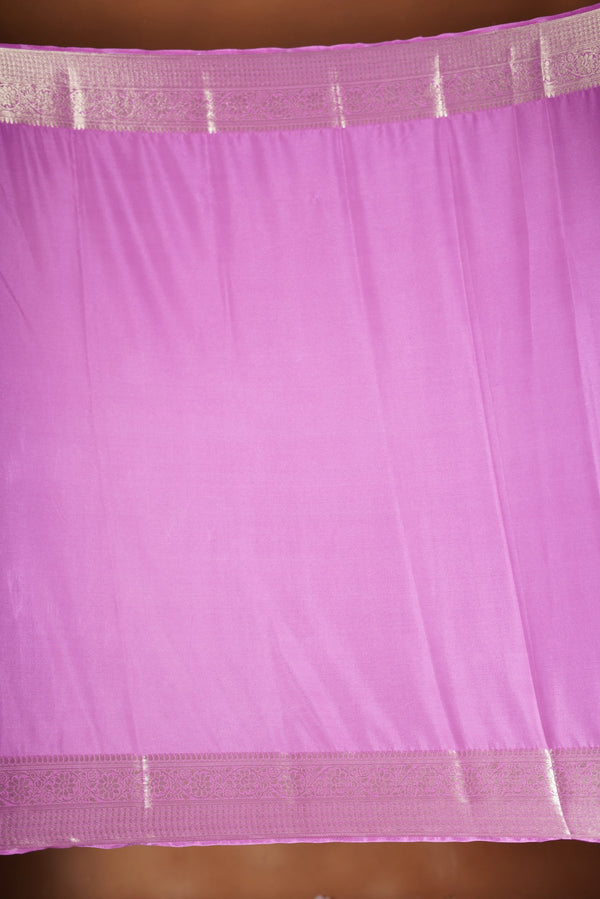 Pink Georgette Saree -  featuring a soft shimmer and intricate woven detailing the floral zari weave. The gentle pastel tone enhances its feminine charm, while the zari border adds a refined finish.