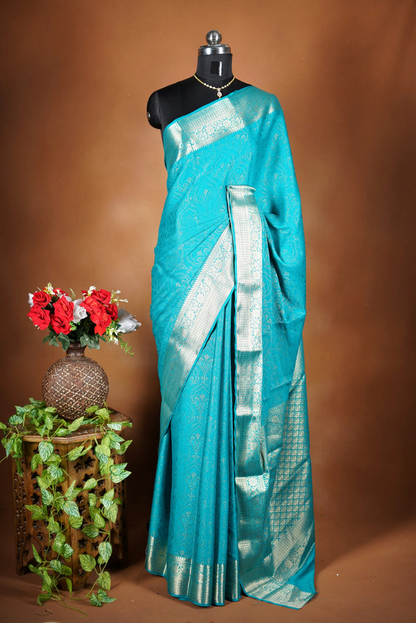 Sky blue Georgette Saree -  Featuring a soft shimmer and intricate woven detailing the floral zari weave. The gentle pastel tone enhances its feminine charm, while the zari border adds a refined finish.