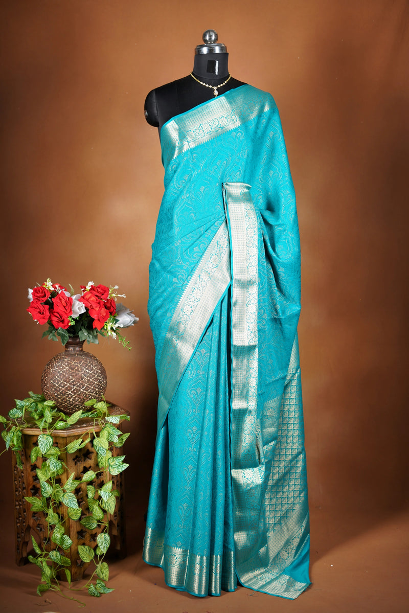Sky blue Georgette Saree -  Featuring a soft shimmer and intricate woven detailing the floral zari weave. The gentle pastel tone enhances its feminine charm, while the zari border adds a refined finish.