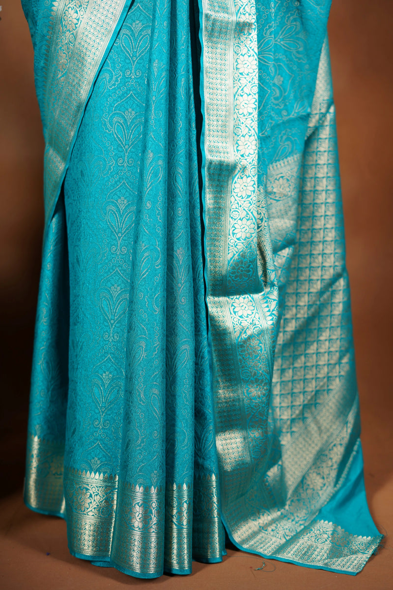 Sky blue Georgette Saree -  Featuring a soft shimmer and intricate woven detailing the floral zari weave. The gentle pastel tone enhances its feminine charm, while the zari border adds a refined finish.