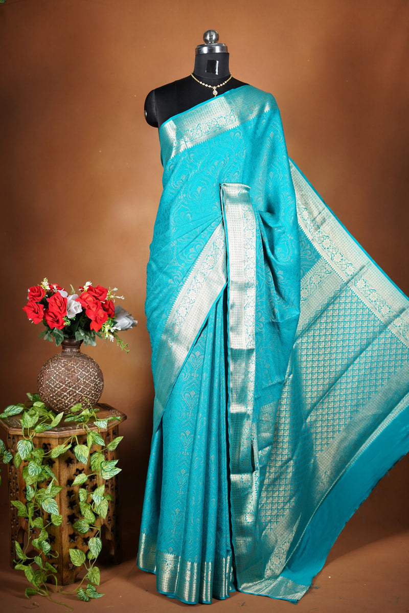 Sky blue Georgette Saree -  Featuring a soft shimmer and intricate woven detailing the floral zari weave. The gentle pastel tone enhances its feminine charm, while the zari border adds a refined finish.