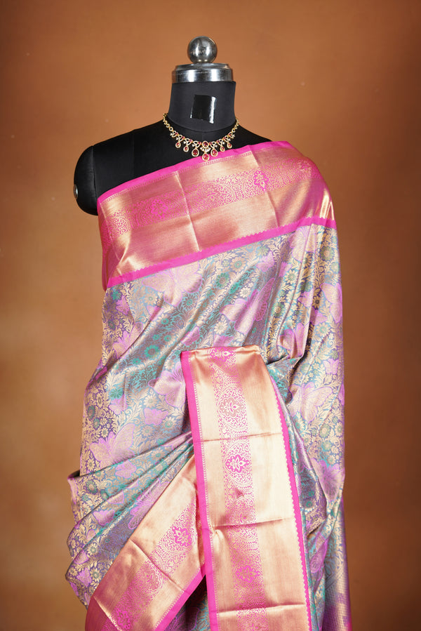 Art Silk Saree - A stunning iridescent grey-silver body accented with a vibrant pink and golden border , self-textured weave with subtle floral&structured golden-pink zari border with traditional panel .