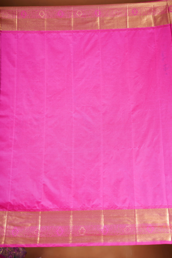 Art Silk Saree - A stunning iridescent grey-silver body accented with a vibrant pink and golden border , self-textured weave with subtle floral&structured golden-pink zari border with traditional panel .