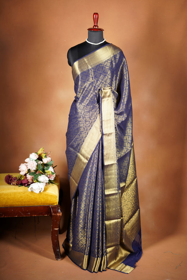 Royal Blue Brocade Geogrette Saree- Featuring all over gold floral zari weaving, rich textured patterns, and a broad gold zari border and pallu, giving a luxurious, elegant, and traditional festive look