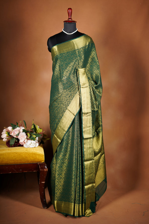 Forest Green Brocade Geogrette Saree- Featuring all over gold floral zari weaving, rich textured patterns, and a broad gold zari border and pallu, giving a luxurious, elegant, and traditional festive look