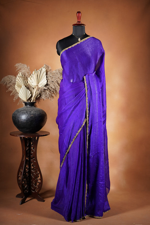 Violet Space Silk Saree – Elegant drape with soft texture and subtle sheen. Enhanced with a refined zari border and attached blouse, this saree blends traditional charm with modern elegance, making it perfect for festive wear and special occasions.