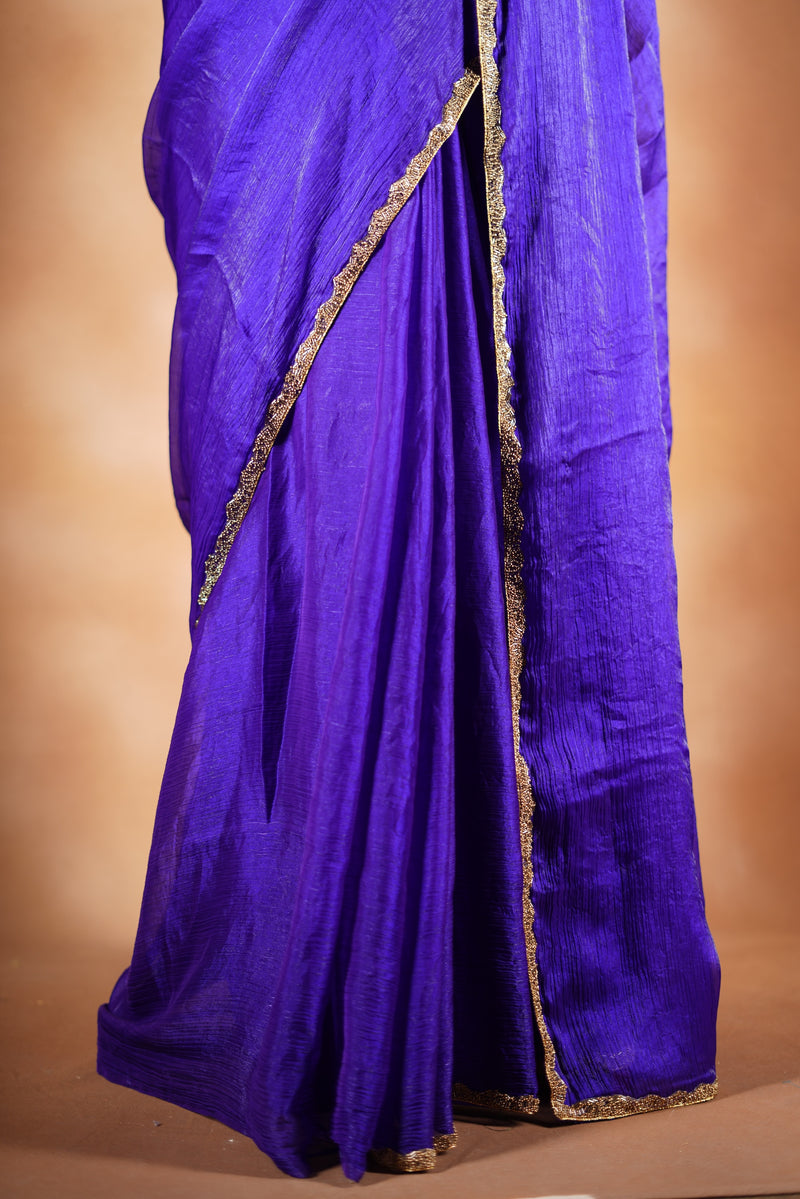 Violet Space Silk Saree – Elegant drape with soft texture and subtle sheen. Enhanced with a refined zari border and attached blouse, this saree blends traditional charm with modern elegance, making it perfect for festive wear and special occasions.