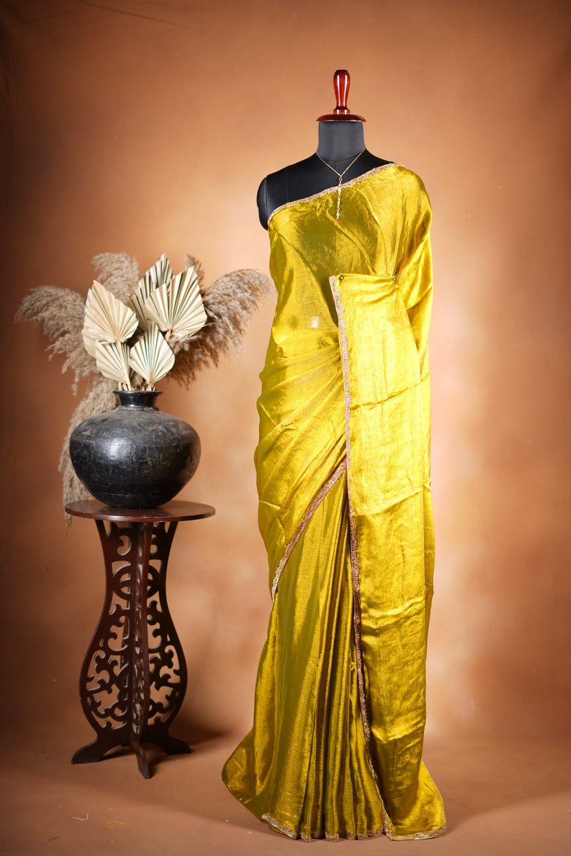 Metallic Gold Space Silk Saree – Brighten your collection with this golden yellow saree, featuring a smooth texture and elegant shine. With a subtle zari border and solid blouse, this lightweight drape blends modern style and traditional grace.