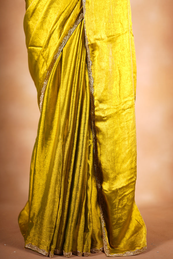 Metallic Gold Space Silk Saree – Brighten your collection with this golden yellow saree, featuring a smooth texture and elegant shine. With a subtle zari border and solid blouse, this lightweight drape blends modern style and traditional grace.