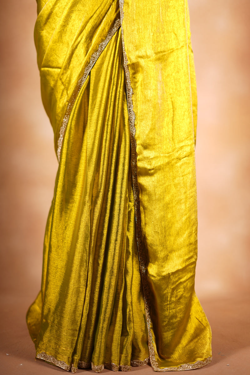 Metallic Gold Space Silk Saree – Brighten your collection with this golden yellow saree, featuring a smooth texture and elegant shine. With a subtle zari border and solid blouse, this lightweight drape blends modern style and traditional grace.