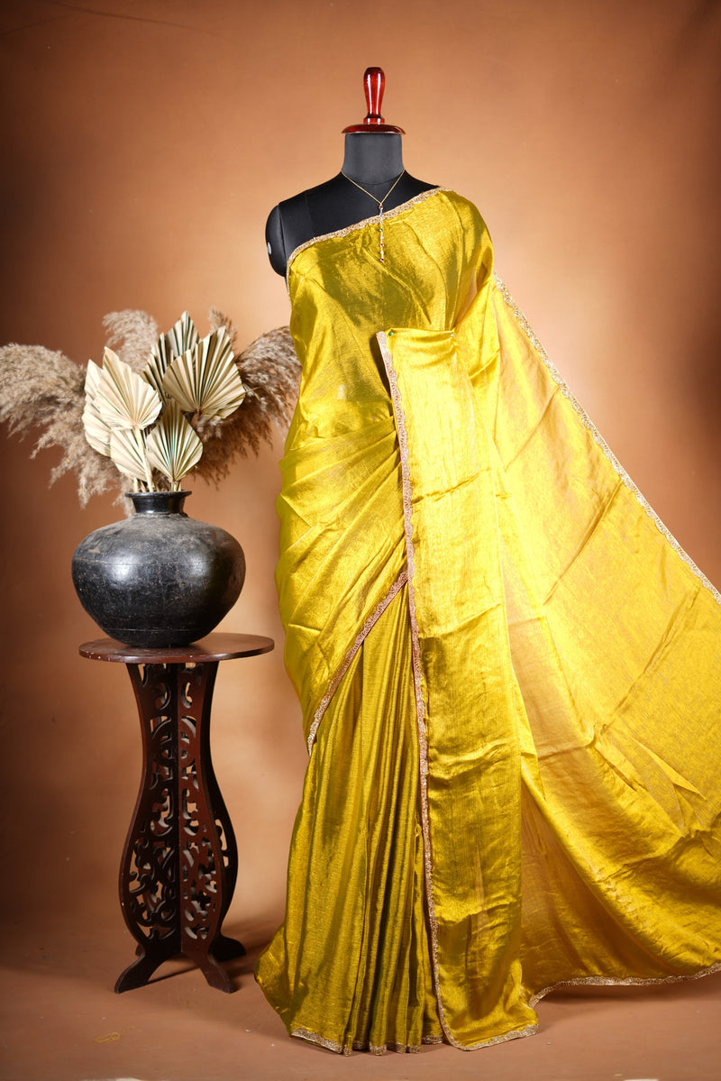 Metallic Gold Space Silk Saree – Brighten your collection with this golden yellow saree, featuring a smooth texture and elegant shine. With a subtle zari border and solid blouse, this lightweight drape blends modern style and traditional grace.