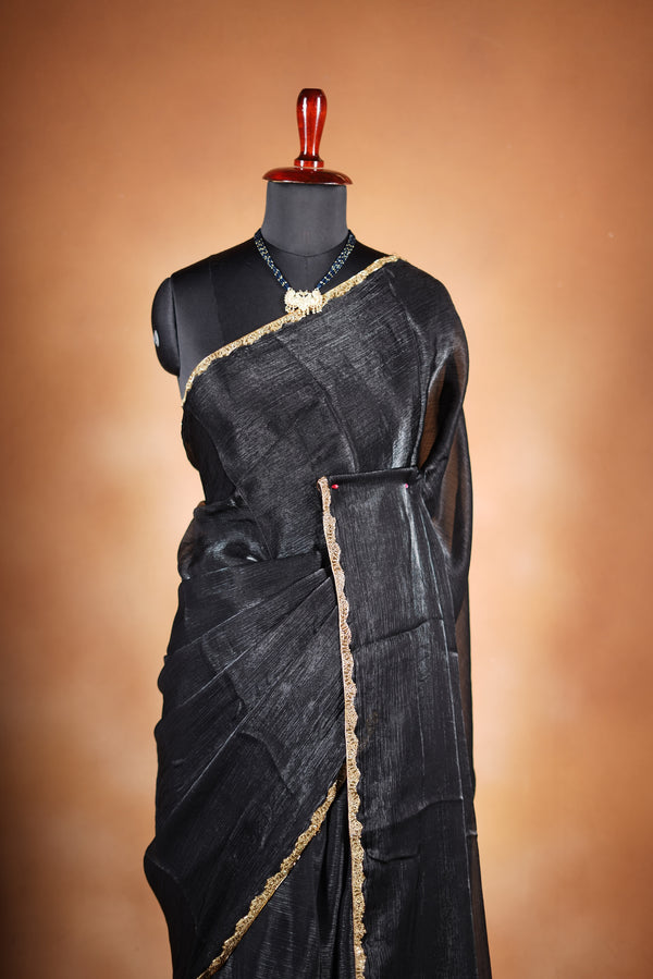 Classic Black Space Silk Saree Elevate your style with this classic black space silk saree, featuring a smooth texture and elegant sheen. Finished with a refined zari border, this lightweight saree blends modern sophistication with traditional charm
