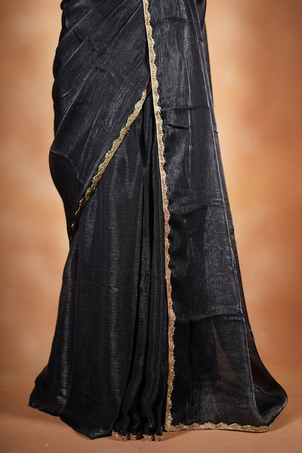 Classic Black Space Silk Saree Elevate your style with this classic black space silk saree, featuring a smooth texture and elegant sheen. Finished with a refined zari border, this lightweight saree blends modern sophistication with traditional charm
