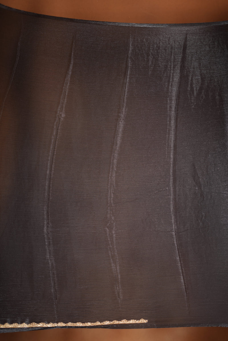 Classic Black Space Silk Saree Elevate your style with this classic black space silk saree, featuring a smooth texture and elegant sheen. Finished with a refined zari border, this lightweight saree blends modern sophistication with traditional charm