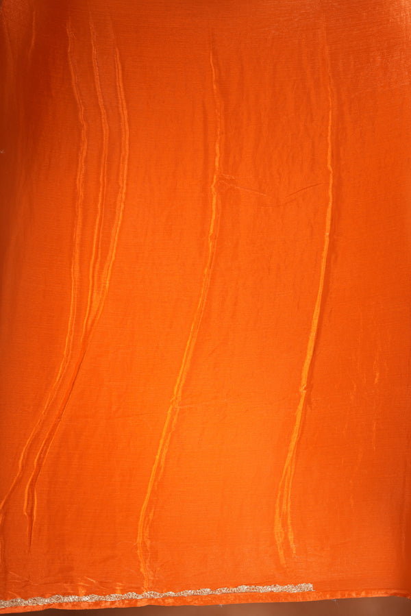 Pop Orange Space Silk Saree – Make a bold statement with this vibrant saree, featuring a smooth glossy finish. Enhanced with a delicate zari border and solid blouse, its lightweight feel blends modern style with traditional elegance for festive occasions.