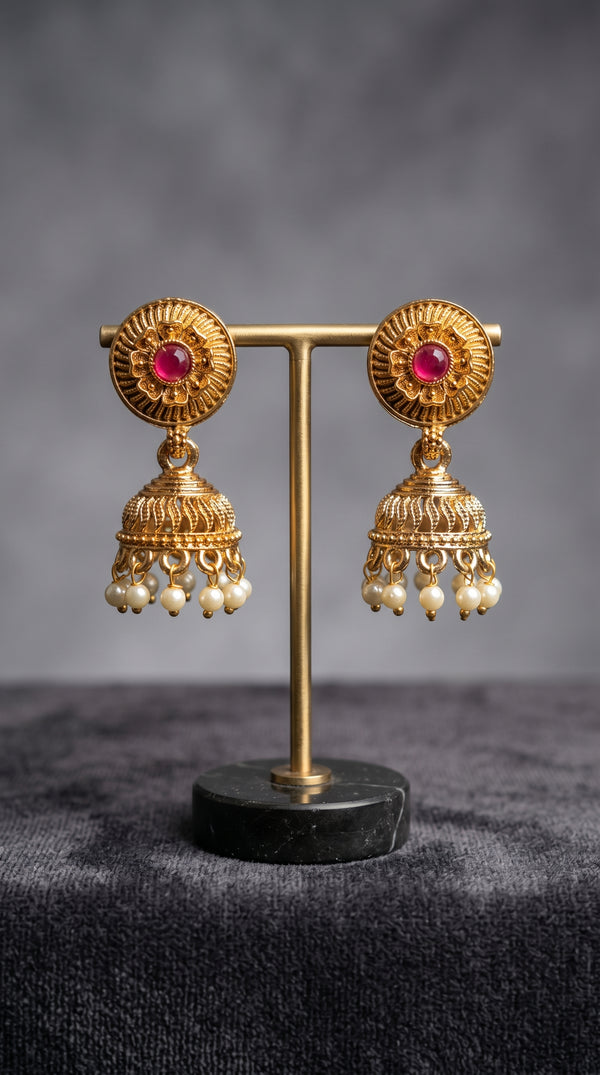 Antique gold jhumka earrings with ruby stone stud design and pearl drops, traditional South Indian temple jewellery for weddings and festive wear.