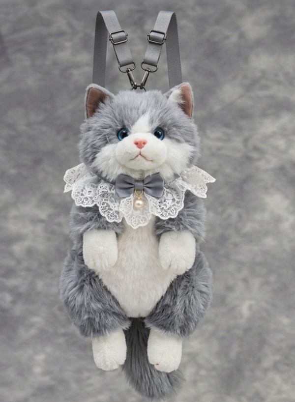 Plush cat toy with a bow tie and lace collar on a gray background