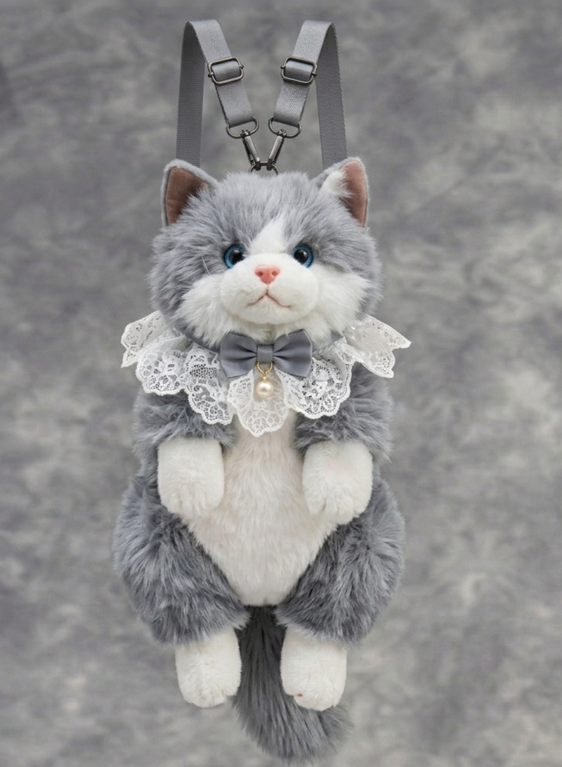 Plush cat toy with a bow tie and lace collar on a gray background