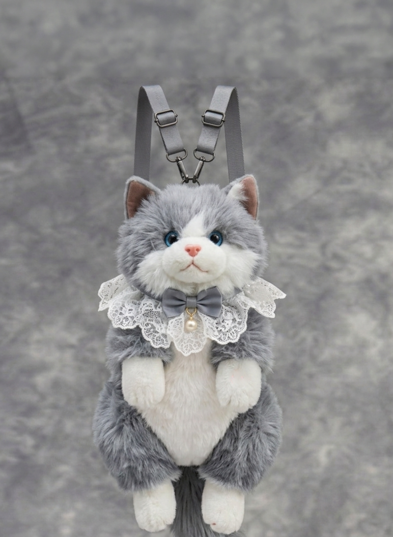 Plush cat toy with a bow tie and lace collar on a gray background