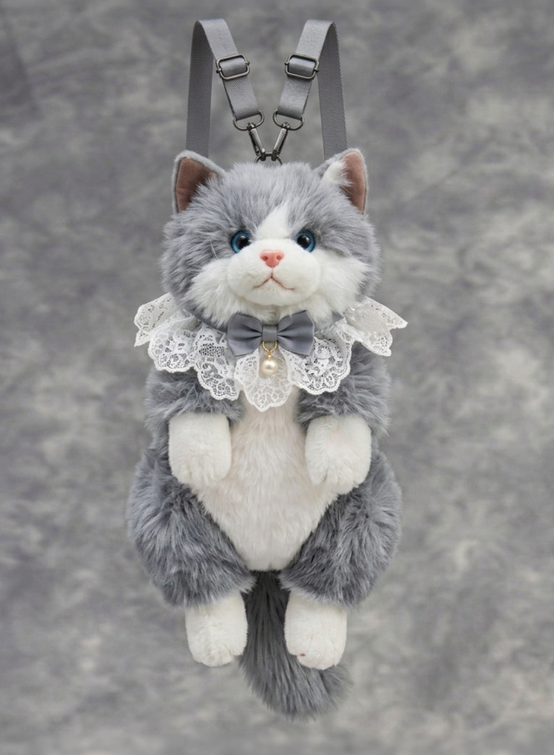 Plush cat toy with a bow tie and lace collar on a gray background 