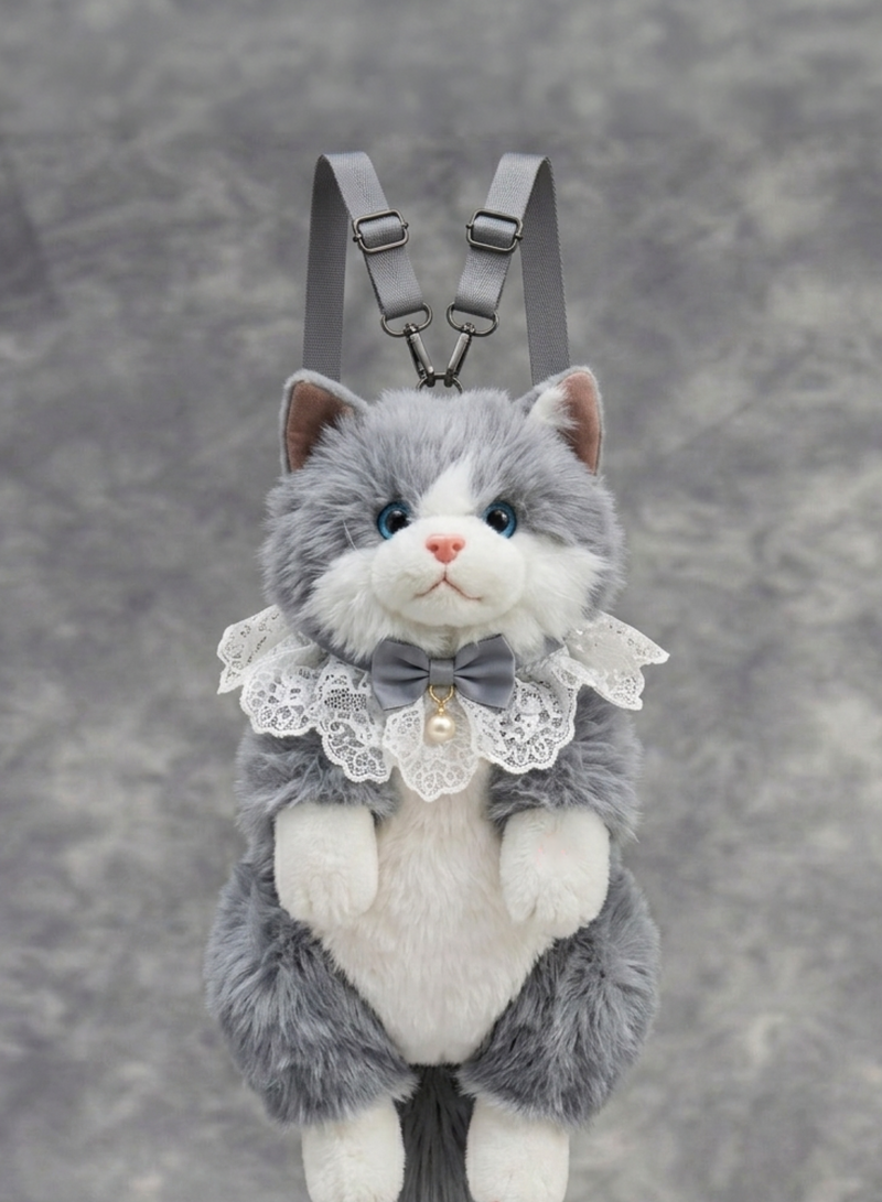 Plush cat toy with a bow tie and lace collar on a gray background