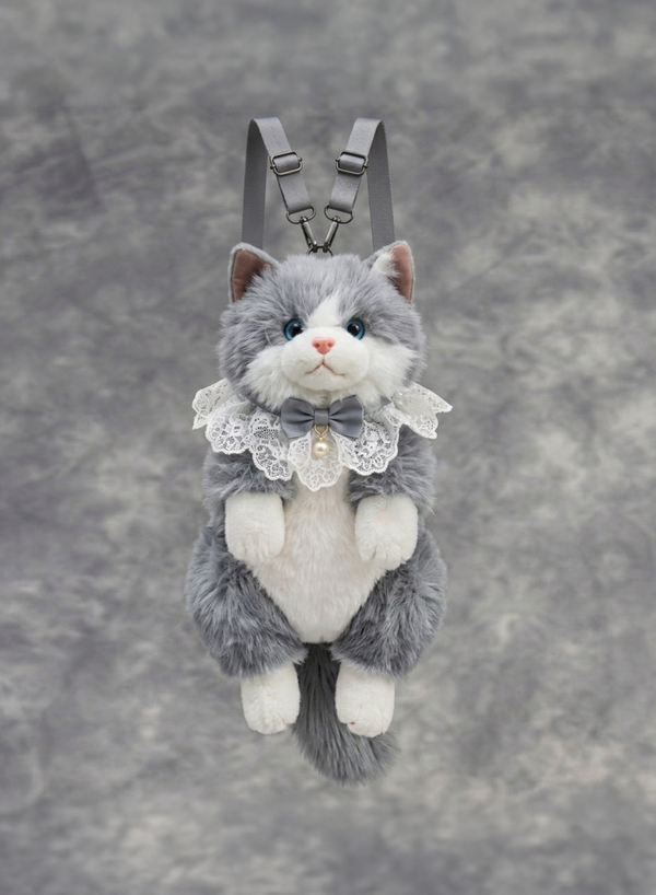 Plush cat toy with a bow tie and lace collar on a gray background