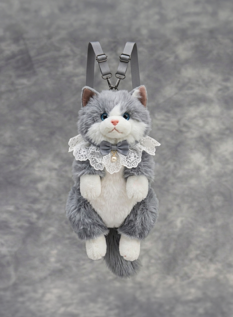Plush cat toy with a bow tie and lace collar on a gray background