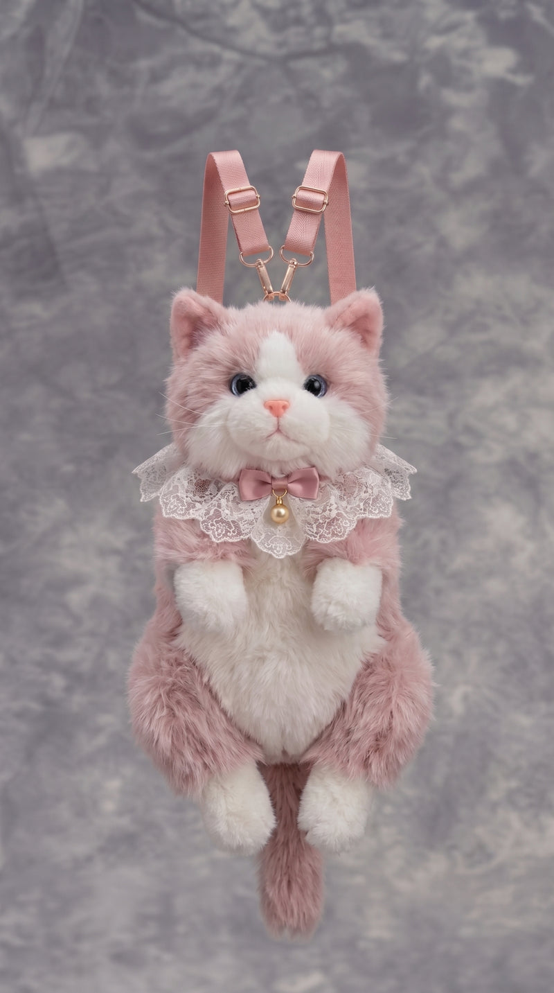 A pink and white plush cat backpack with a lace collar, bow, and gold bell, featuring pink shoulder straps and a gold chain connector, set against a textured gray background.