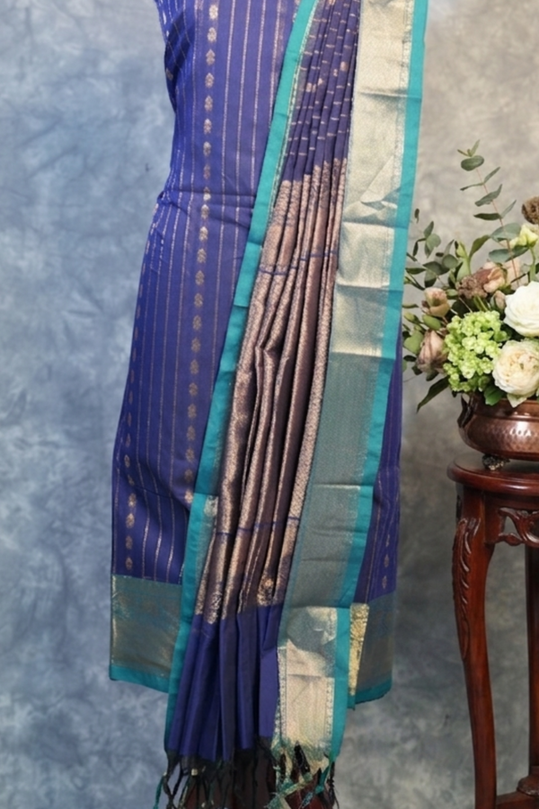 Blue saree with a floral arrangement on a gray background